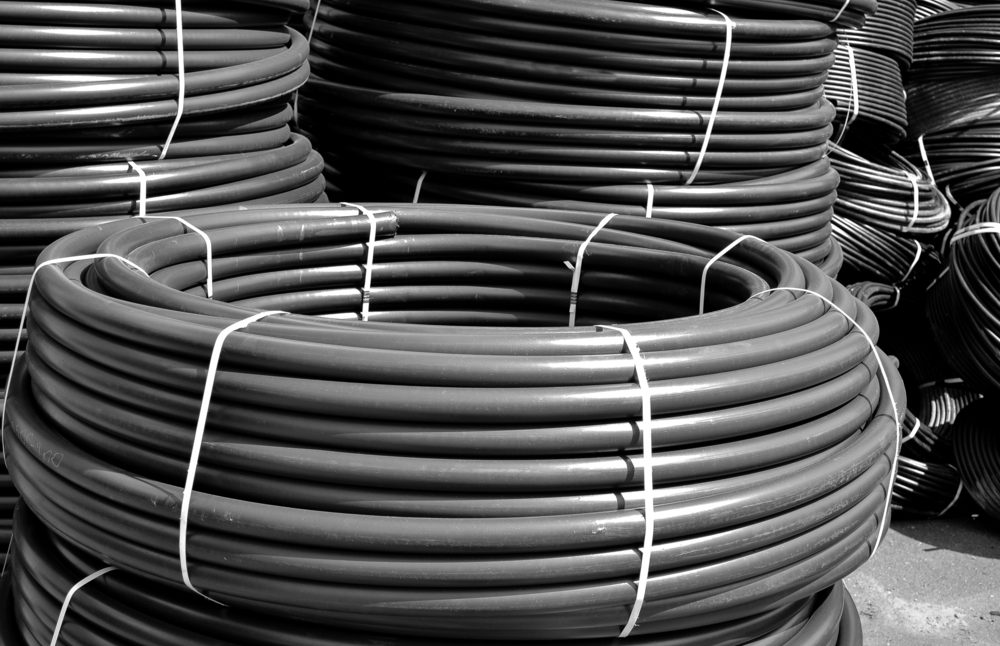 Coiled,Black,Plastic,Pipes,Stored,Outdoors